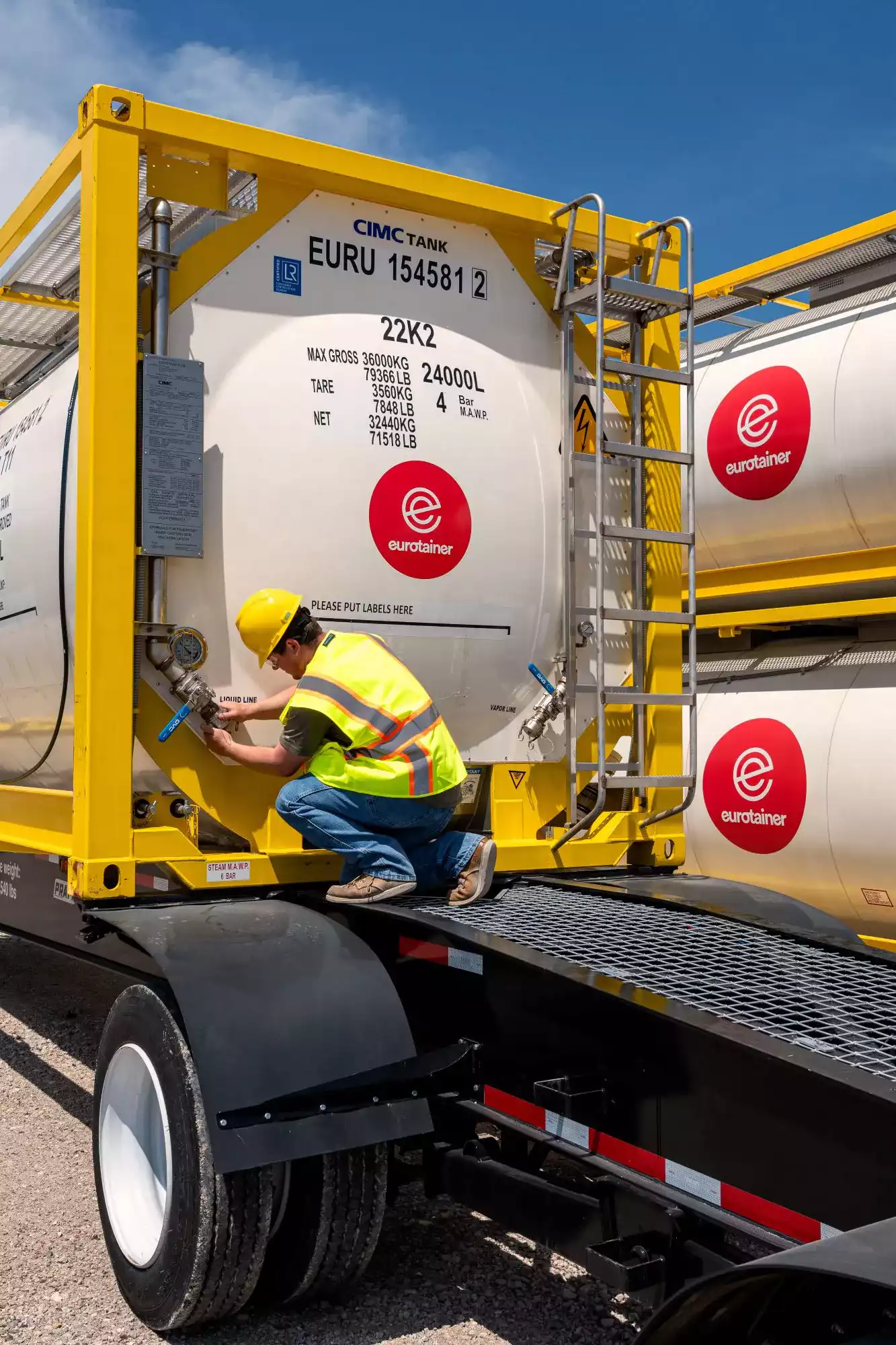 Tank container liquid with govr on chassis with technician - eurotainer