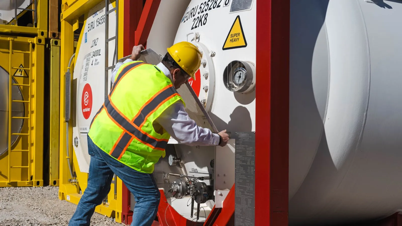 Technician opening valve box on end of gas tank container T50 - eurotainer